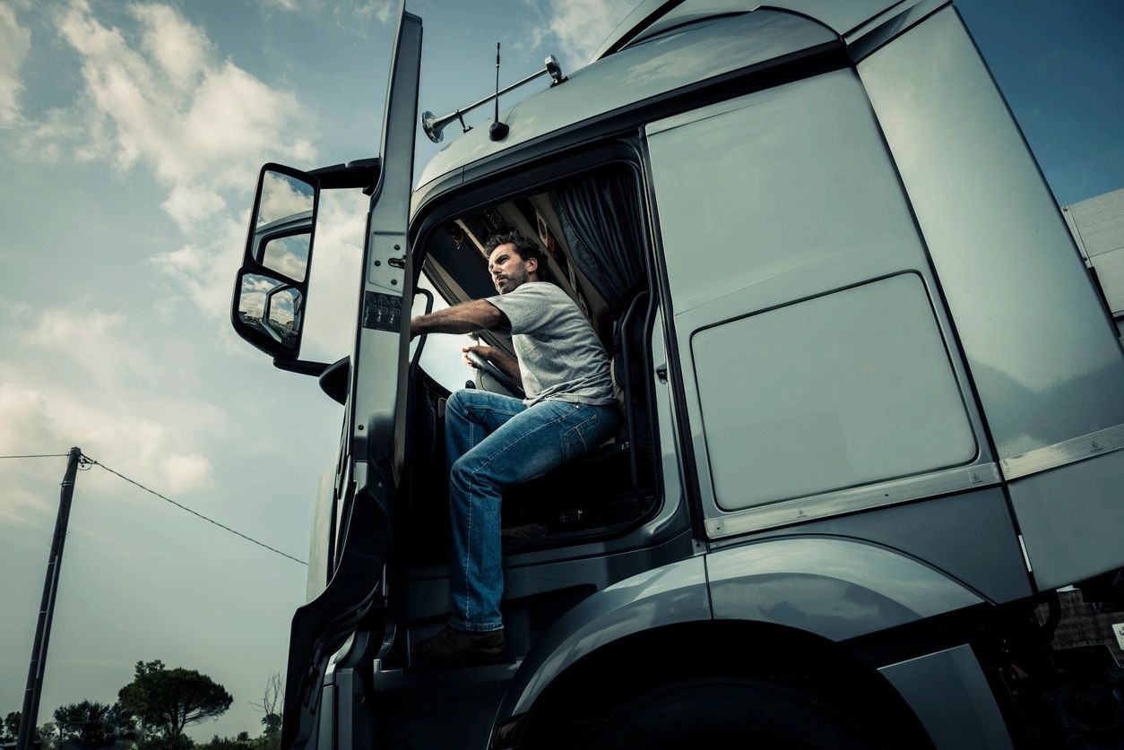 a man getting down from a truck